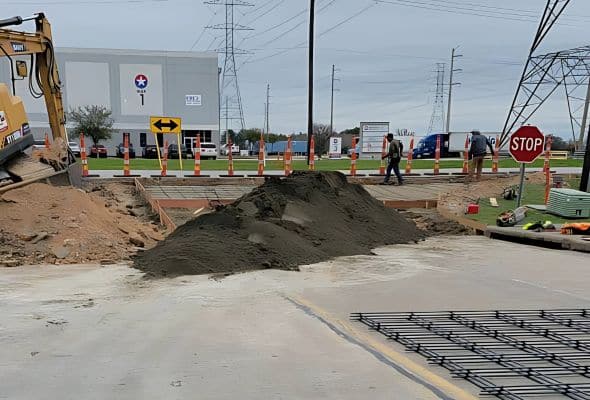 Concrete contractors replacing a commercial driveway approach at a shopping center near Houston, ensuring a durable and smooth surface for heavy traffic.